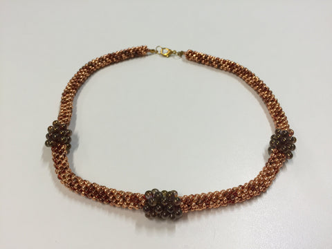 Beautiful gold-clasped necklace in bronze and gold with wine coloured treats